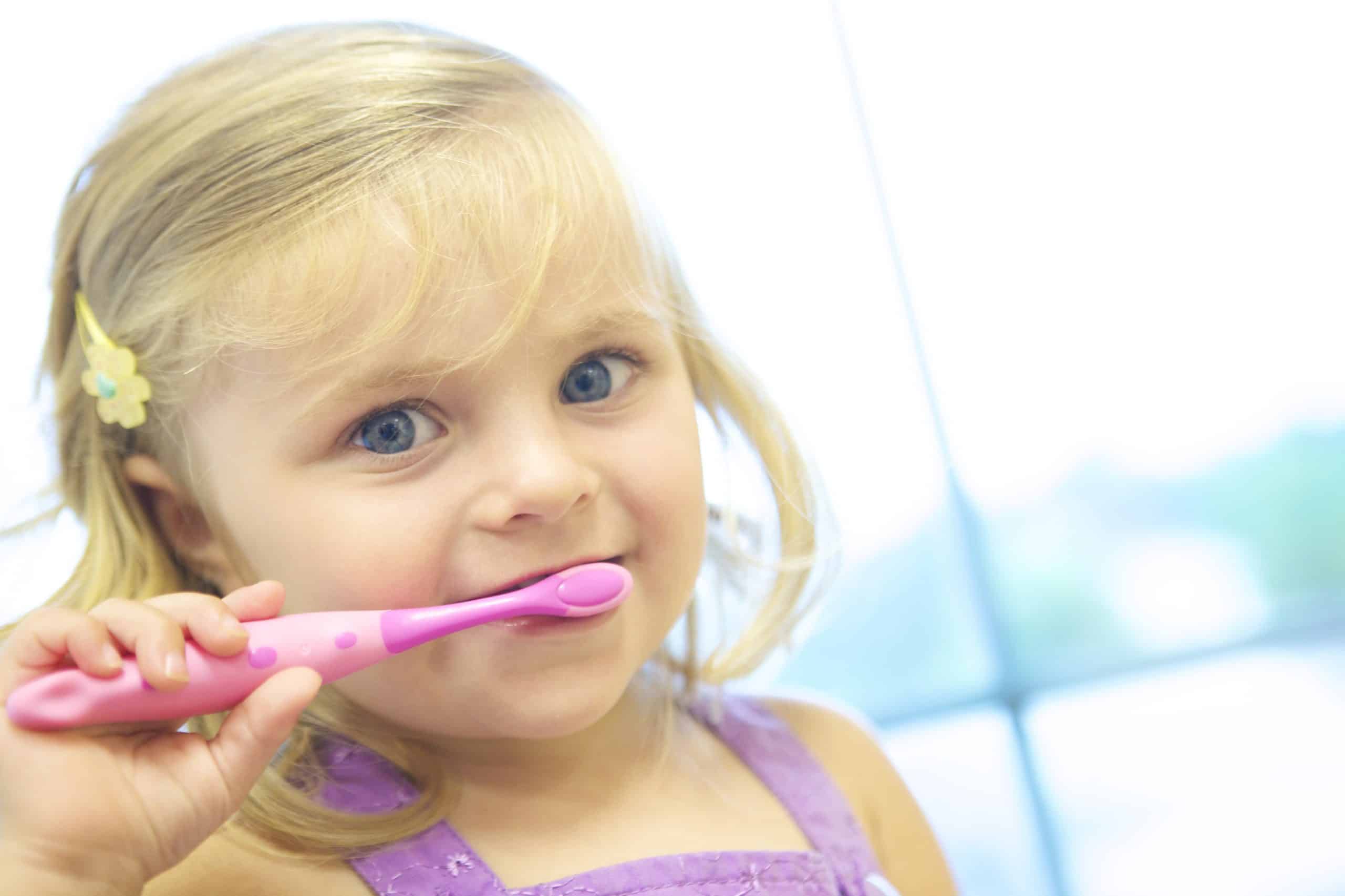 child brushing teeth