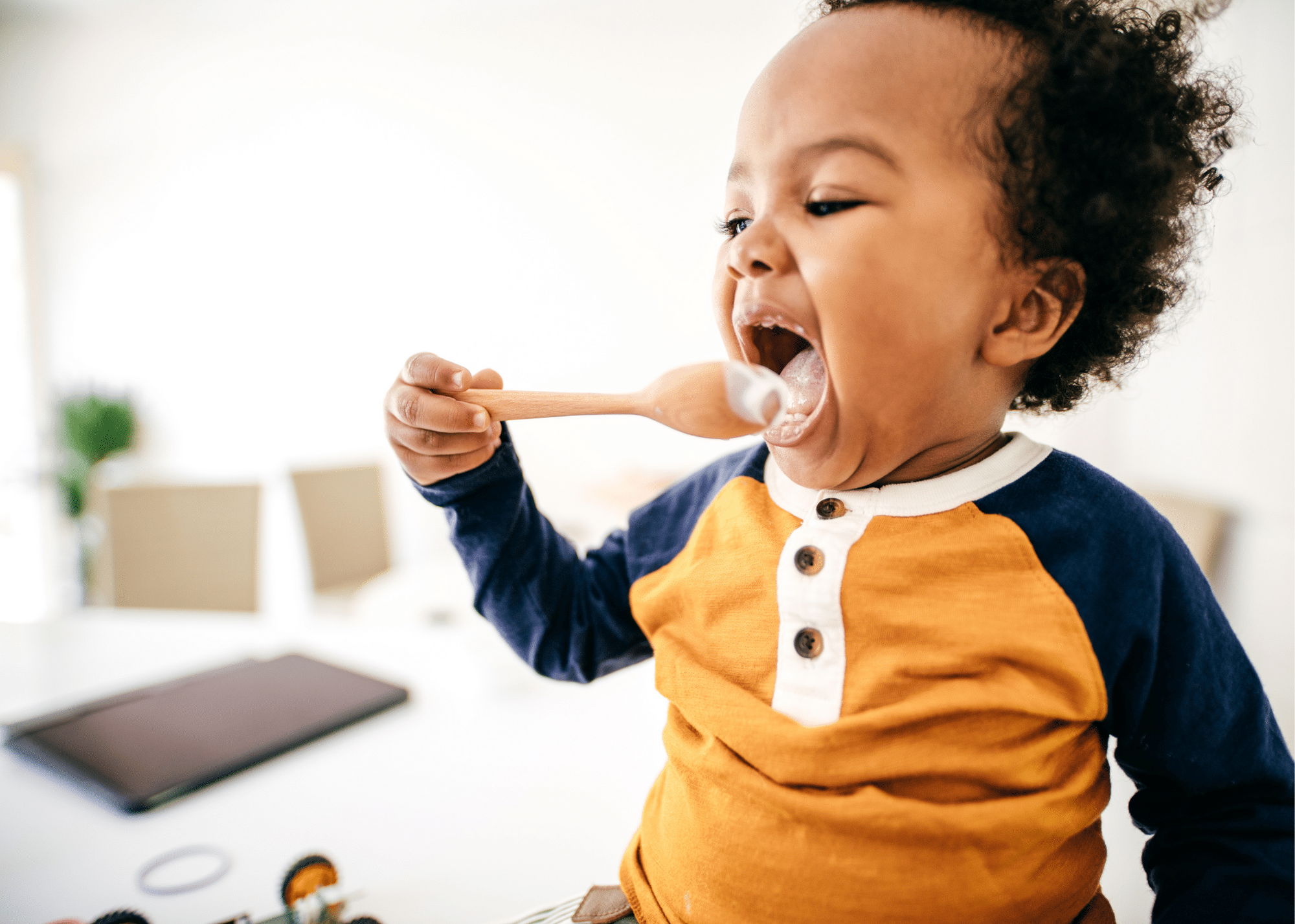 child licking spoon