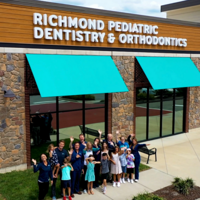 Richmond Pediatric Dentistry & Orthodontics team outside of office, waving up at camera