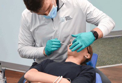 RPDO orthodontist working on a patient's teeth, representing Orthodontic Health Month