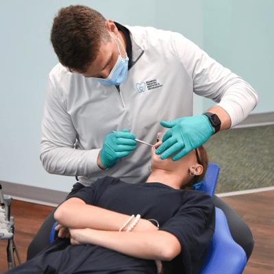 RPDO orthodontist working on a patient's teeth, representing Orthodontic Health Month