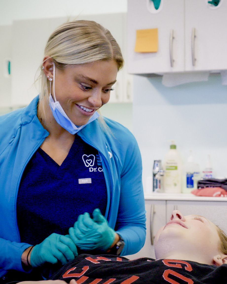Braces in Richmond, VA: Orthodontic Care for Kids, Teens, and Adults 2 Dr. Cook, Orthodontist in Richmond, VA, smiling warmly with a young patient at Richmond Pediatric Dentistry & Orthodontics