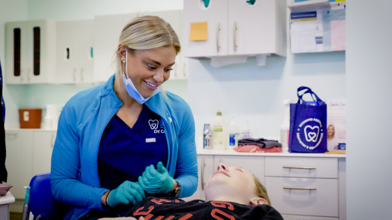 Dr. Payton Cook smiling with a patient in the orthodontic chair at RPDO