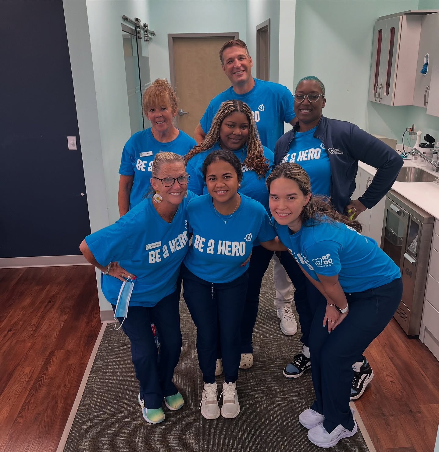 The Richmond Pediatric Dentistry and Orthodontics orthodontic team, including Dr. Bibona, wearing matching "Be a Hero" shirts at the RPDO office during a community outreach event