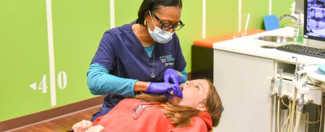 Pediatric dentist that accepts Medicaid in Richmond examines a young patient at RPDO