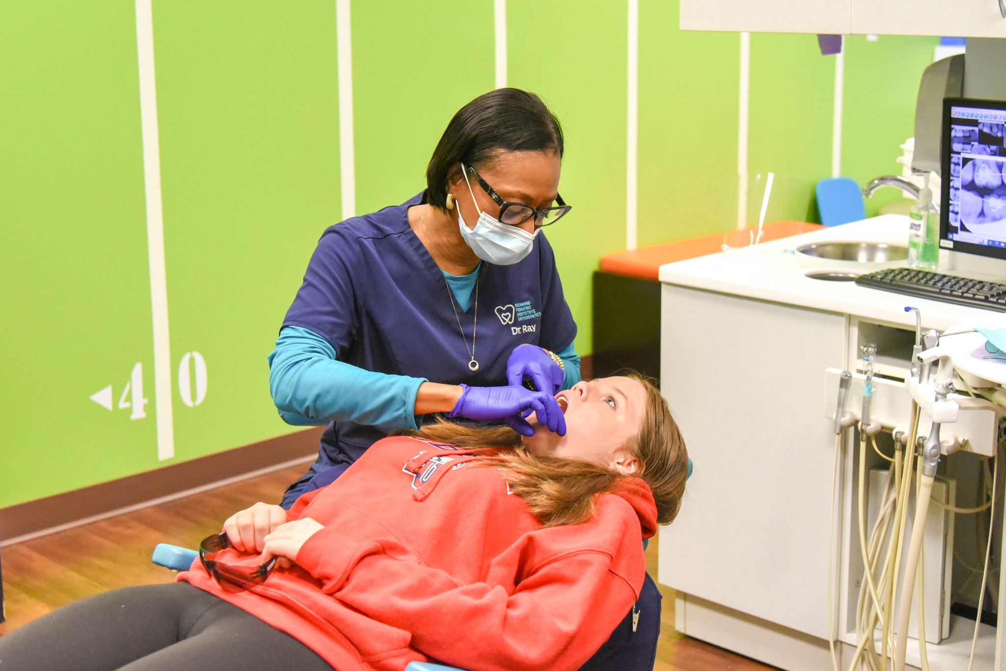 Pediatric dentist that accepts Medicaid in Richmond examines a young patient at RPDO