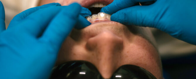 Orthodontist fitting a clear aligner for a patient at Richmond Pediatric Dentistry and Orthodontics