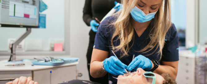Orthodontist for teens in Richmond adjusting a teen patient's braces
