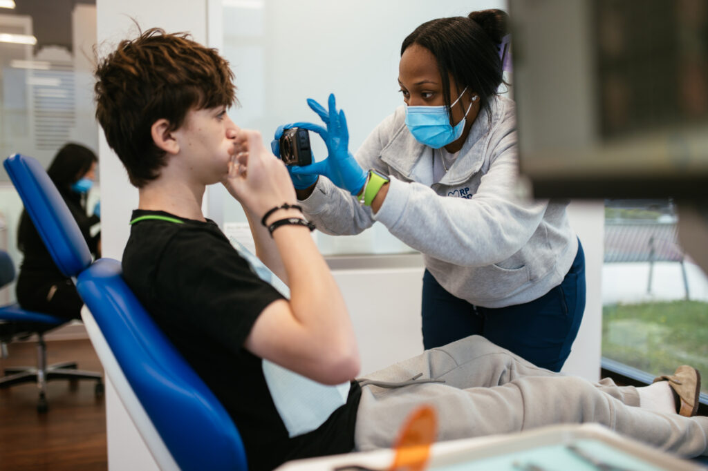 Location Richmond 6 RPDO orthodontic team member taking intraoral photos during a teen's first orthodontic consultation