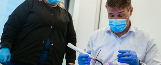 Orthodontist and dental assistant bonding braces with a curing light at RPDO in Richmond, VA
