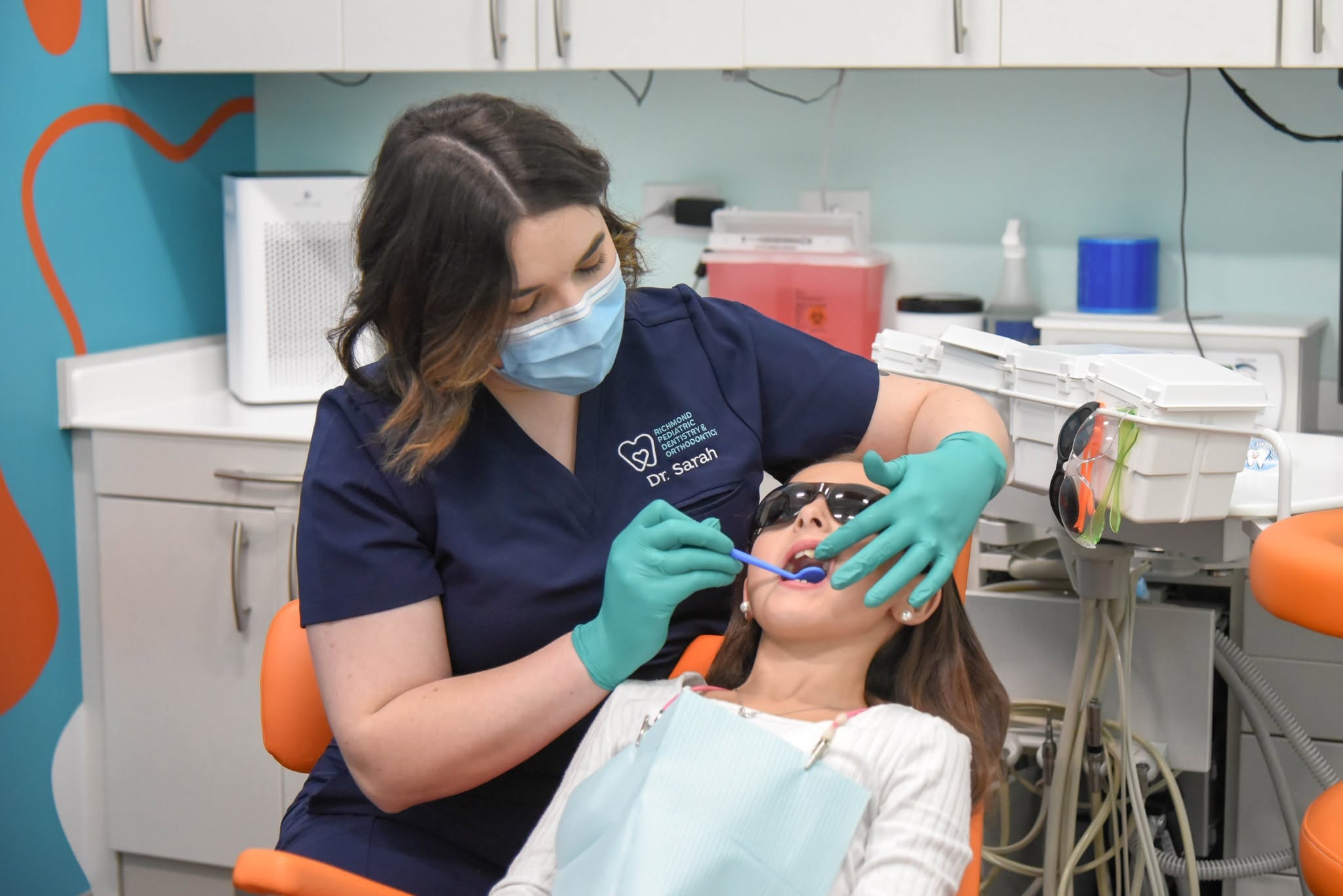 Dr. Sarah Yi examining a young patient at Richmond Pediatric Dentistry and Orthodontics in Richmond, VA