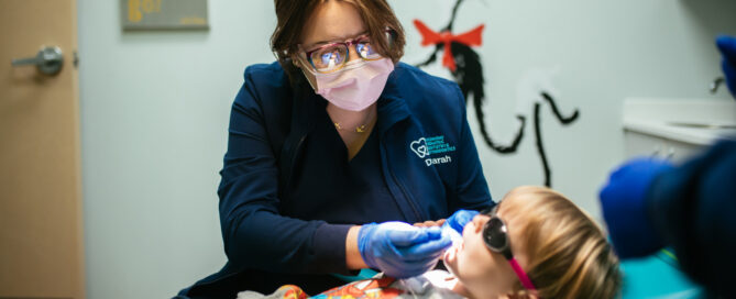 Teeth Cleaning for Kids in Midlothian, VA 2 A pediatric dental team member gently cleans a young child's teeth at Richmond Pediatric Dentistry and Orthodontics in Midlothian, VA