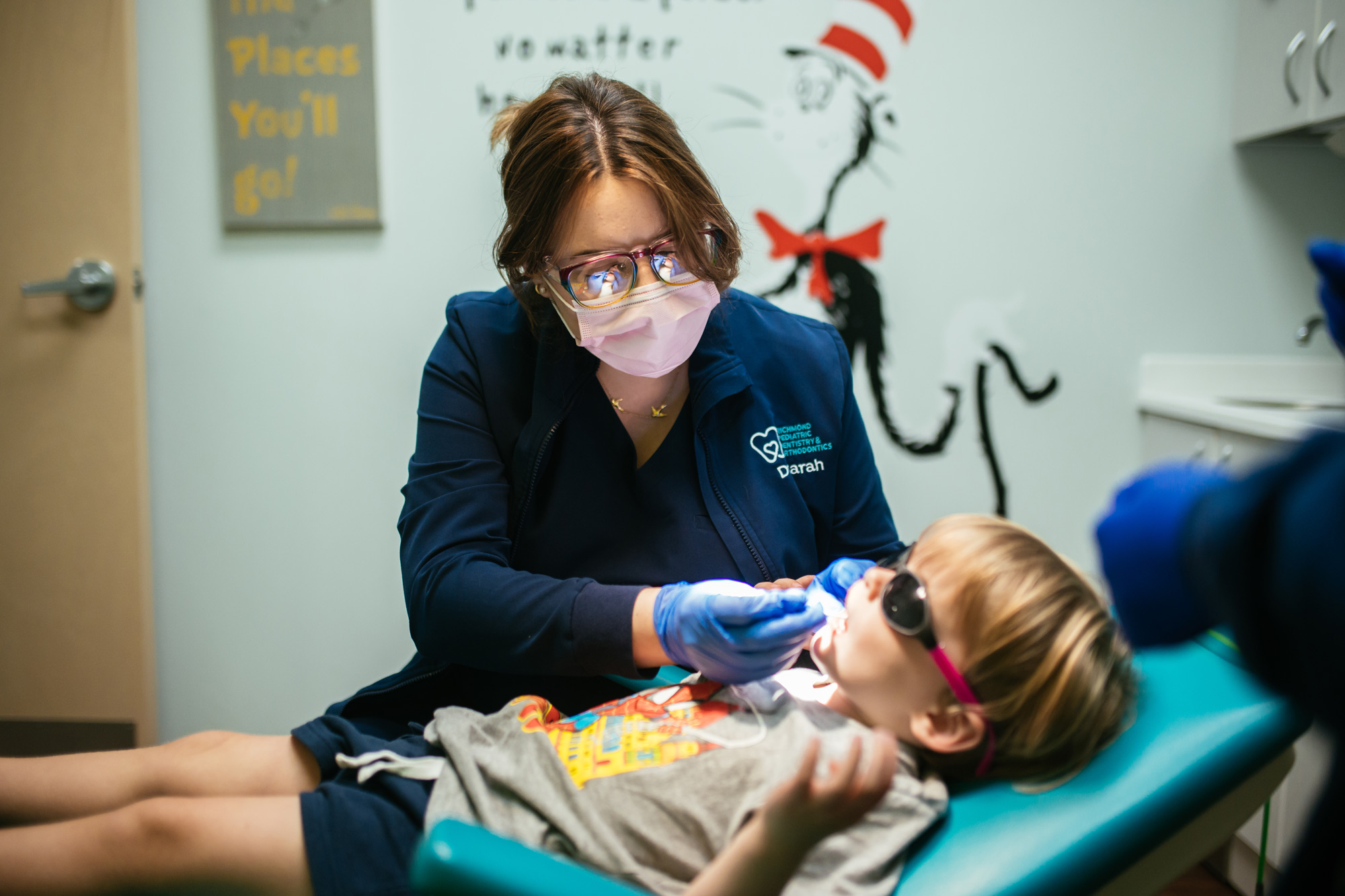 A pediatric dental team member gently cleans a young child's teeth at Richmond Pediatric Dentistry and Orthodontics in Midlothian, VA