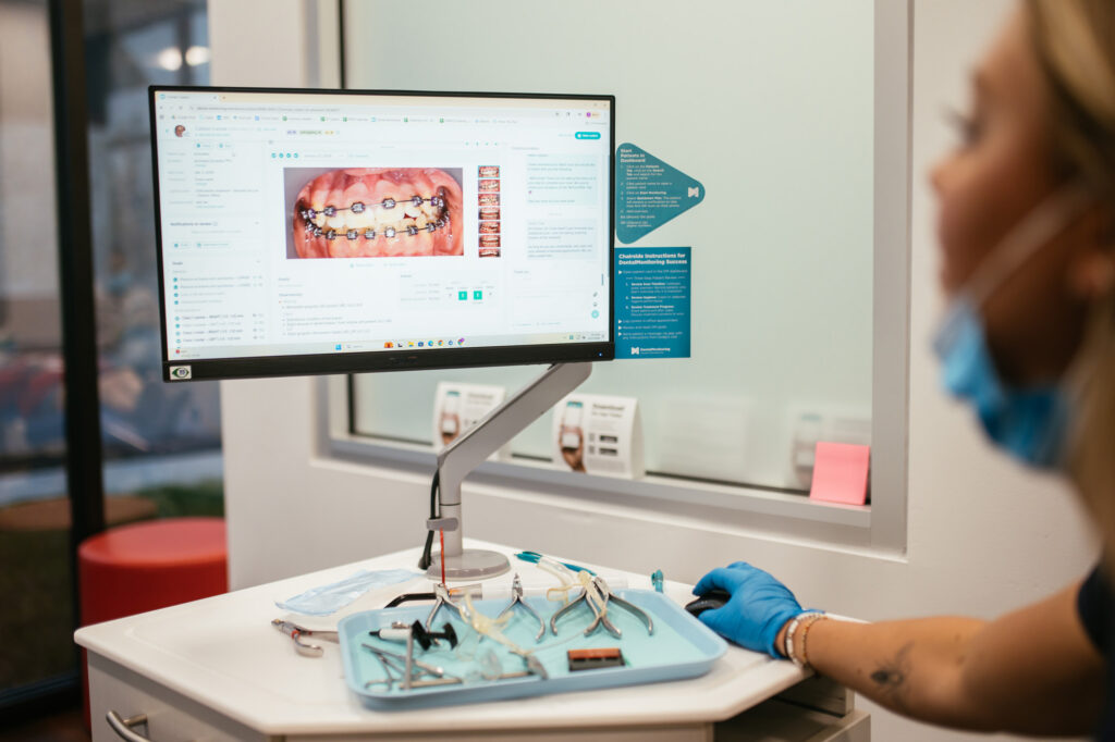 Orthodontist in Richmond, VA 15 RPDO team member reviewing orthodontic treatment progress on a screen with Dental Monitoring