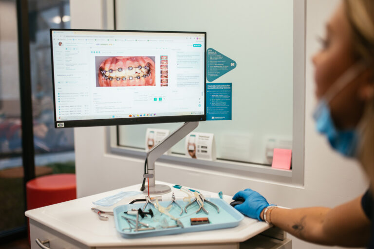 RPDO team member reviews orthodontic treatment progress on a digital dashboard at our Richmond, VA office