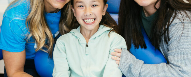 Orthodontist in Richmond, VA 2 RPDO team members smile with a young patient in the exam chair at our Richmond, VA orthodontic office