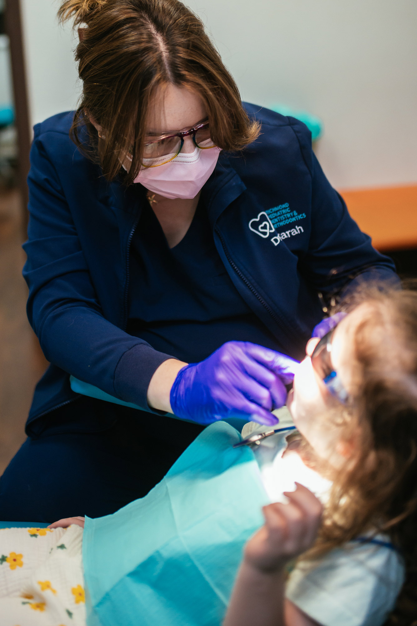 Young girl having her teeth checked by a pediatric dental team member at Richmond Pediatric Dentistry & Orthodontics, a children's dentist near Glen Allen, Virginia