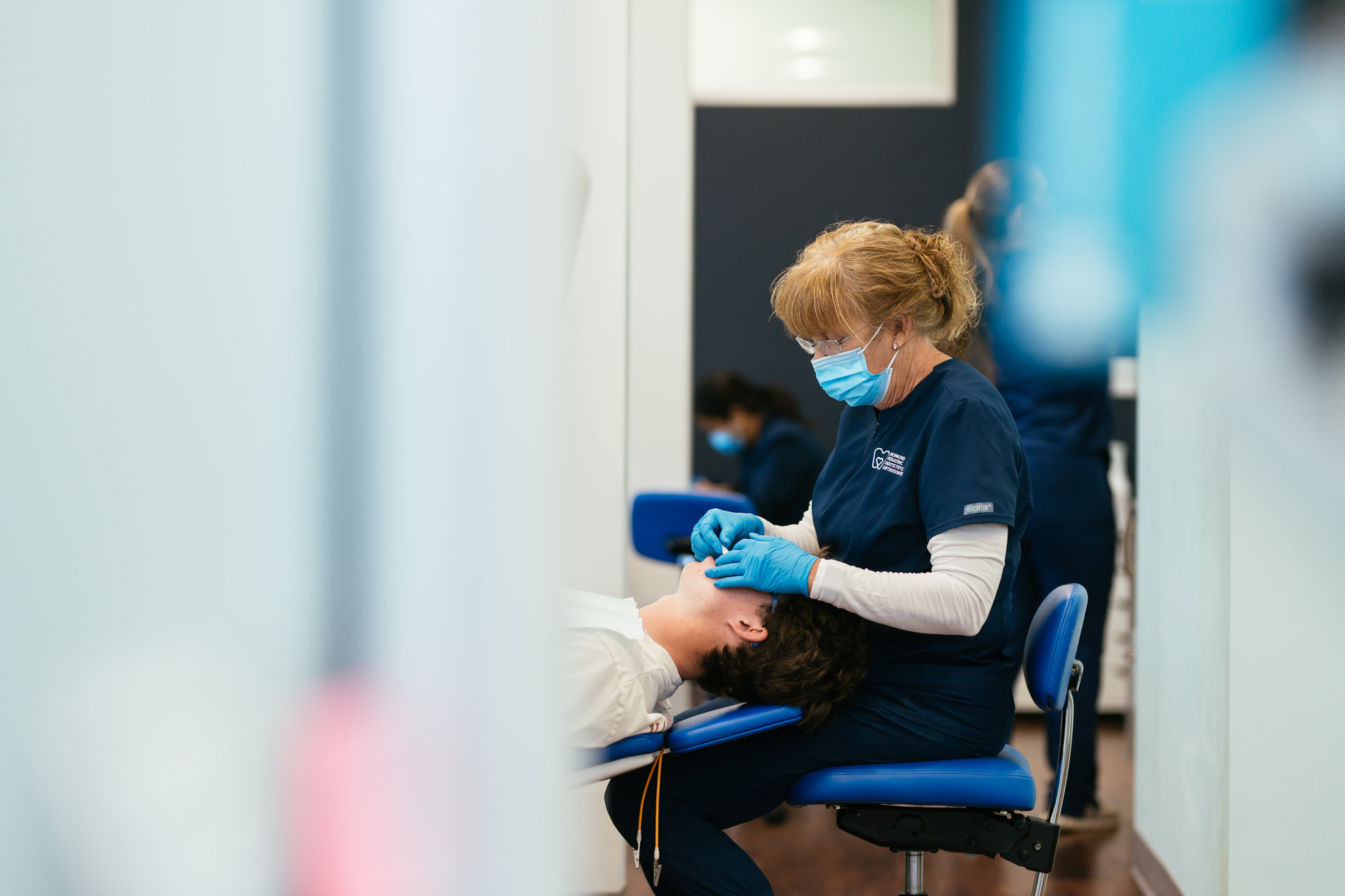 Clinical team member treating a patient in the chair at Richmond Pediatric Dentistry and Orthodontics