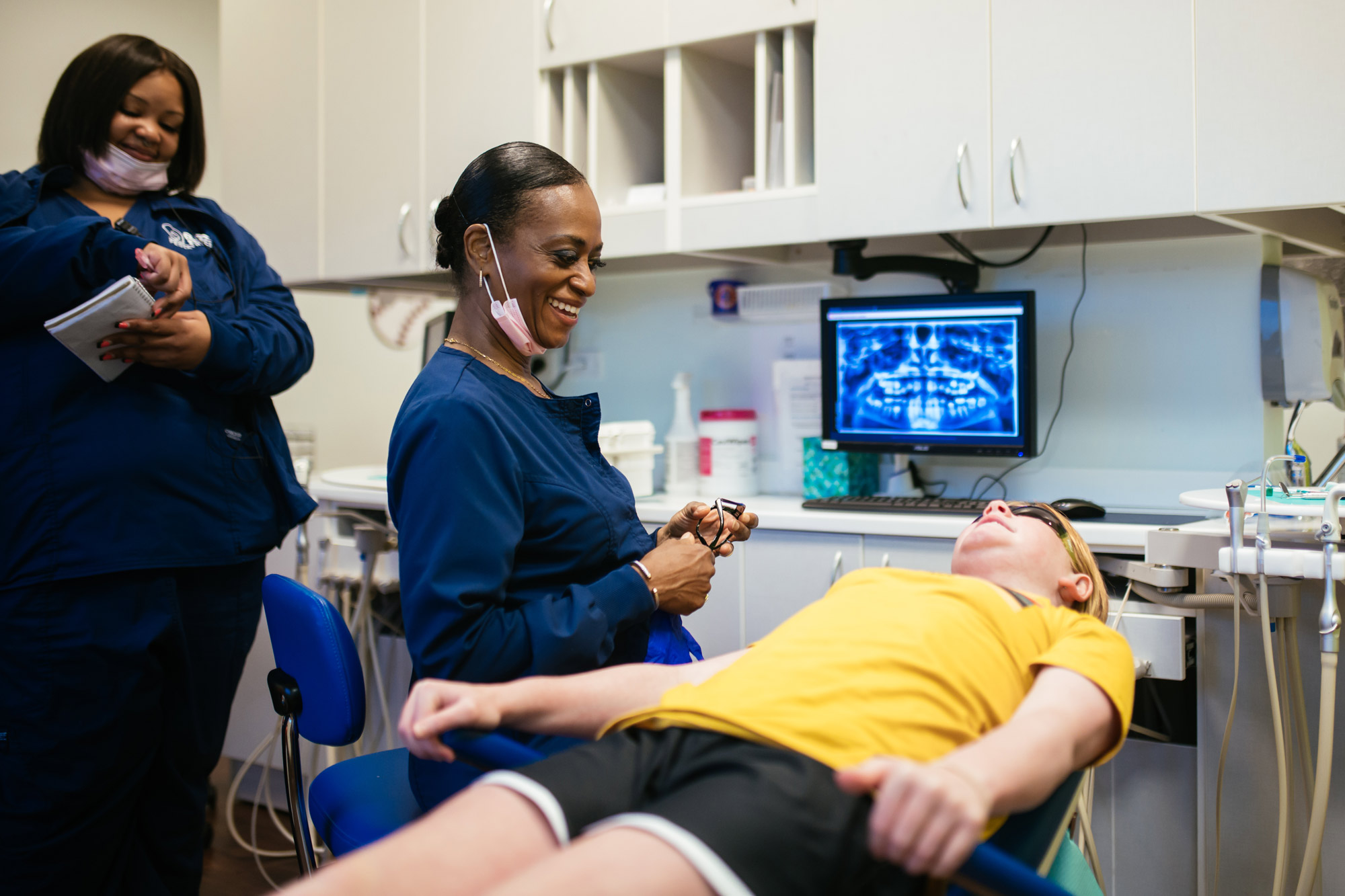 Pediatric dental team members with a young patient during a visit at Richmond Pediatric Dentistry & Orthodontics, serving Glen Allen and Henrico County