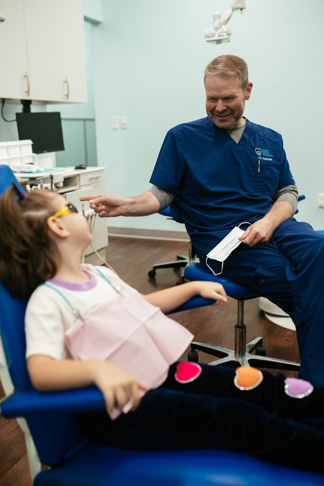 Dr. Bill Dahlke, pediatric dentist at Richmond Pediatric Dentistry and Orthodontics, laughing with a young patient in the dental chair in Henrico County, VA