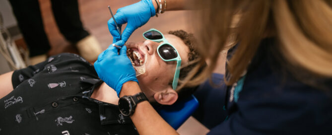 Underbite Correction in Richmond, VA 2 Orthodontic assistant adjusting braces for a teen patient at Richmond Pediatric Dentistry and Orthodontics in Richmond, VA
