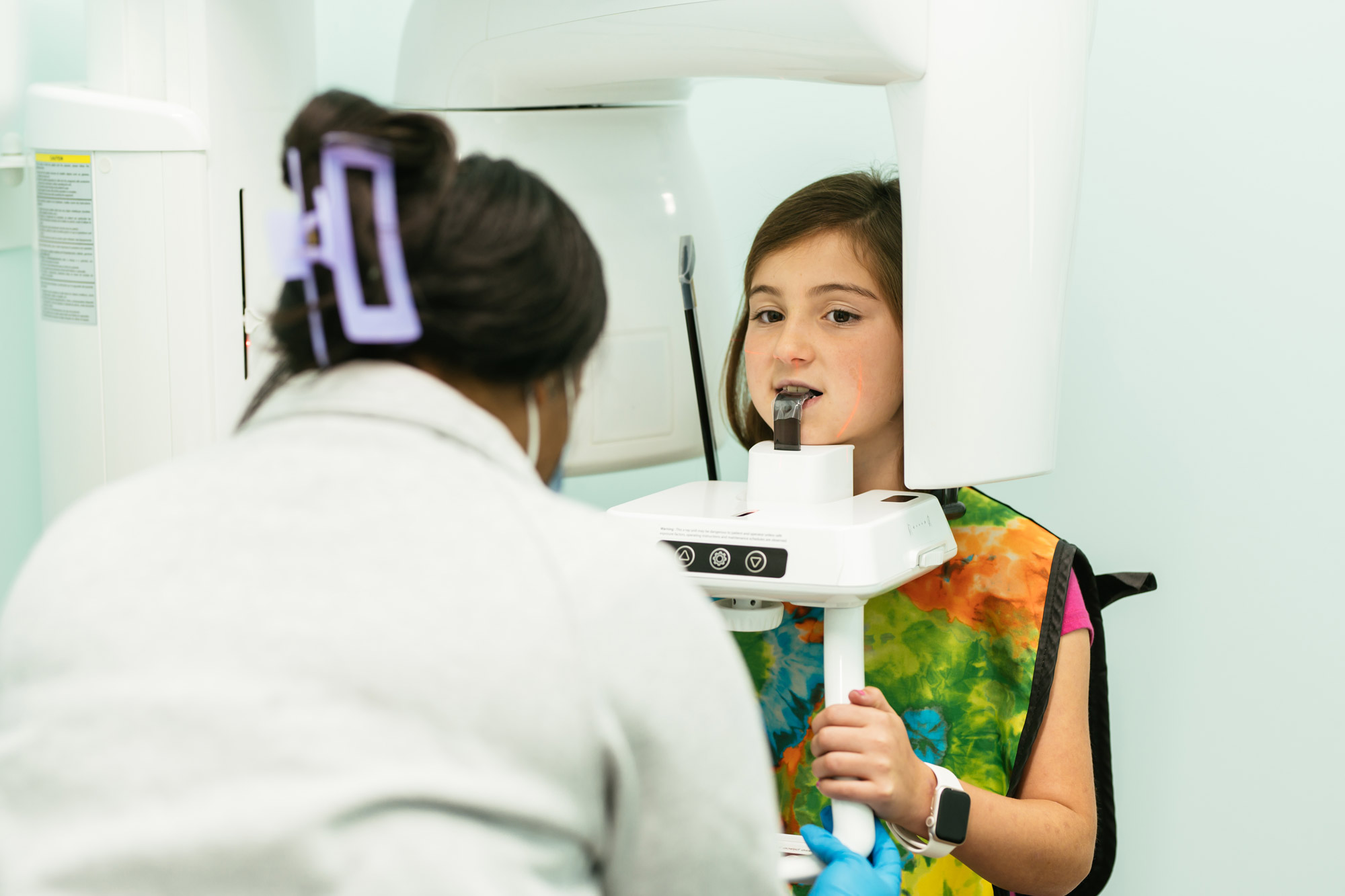Young patient having a panoramic X-ray taken to evaluate jaw position and bite at a Richmond, VA orthodontic office