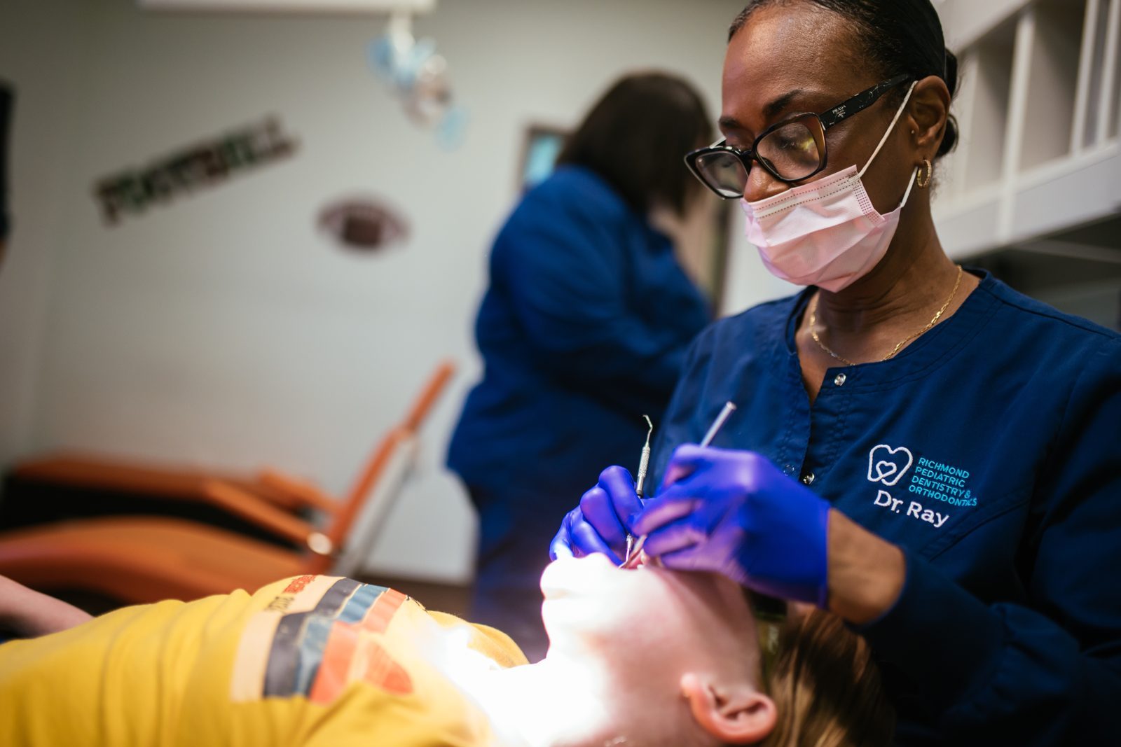 Restorative Dentistry 6 Dr. Raymonia Eddleton (Dr. Ray) works on a child's tooth under the dental light at Richmond Pediatric Dentistry and Orthodontics in Richmond, VA