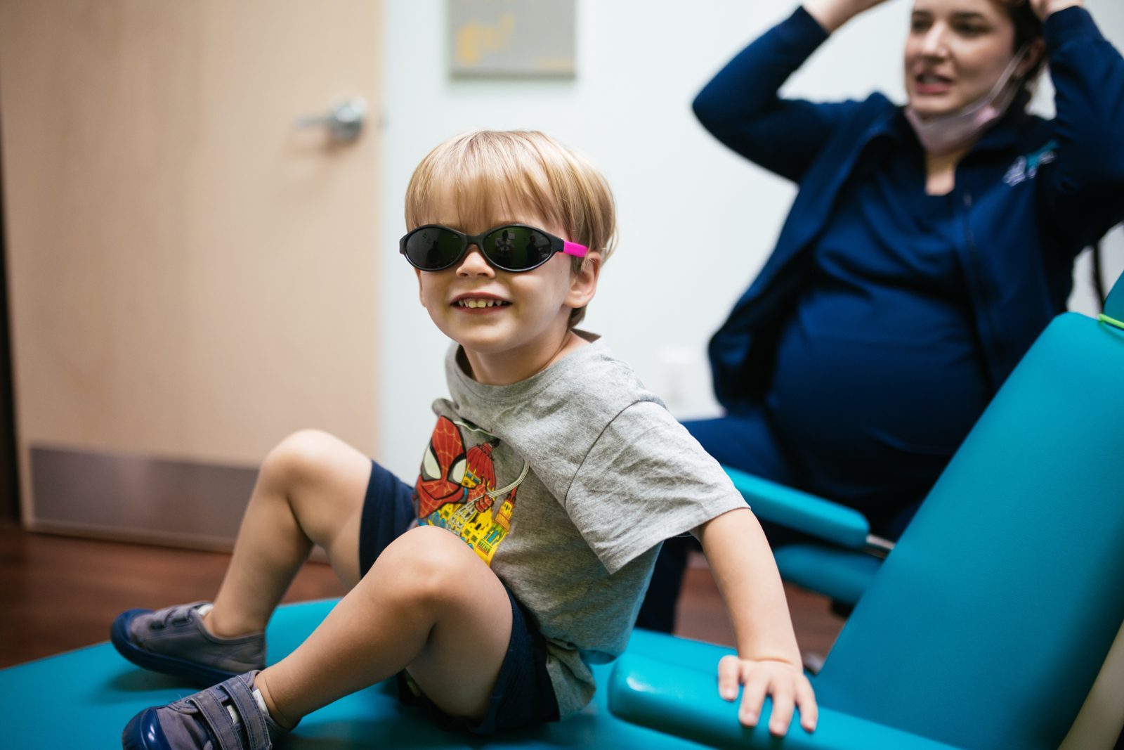 Restorative Dentistry 7 A smiling boy in kid-sized sunglasses sits up in the dental chair after his visit at Richmond Pediatric Dentistry and Orthodontics in Richmond, VA