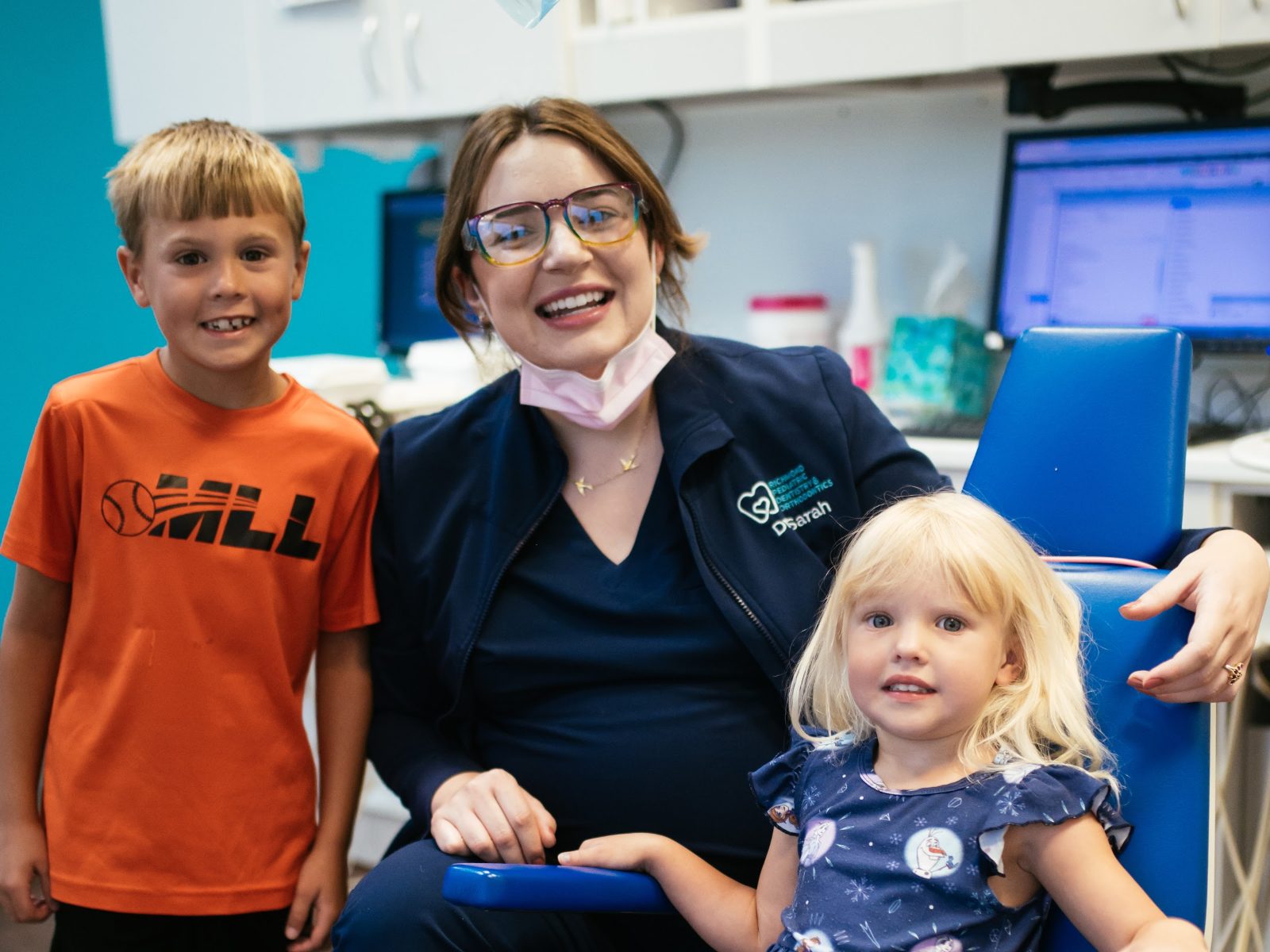 Teeth Cleaning for Kids in Richmond, VA 11 Two young patients smiling with their RPDO hygienist at a dental visit in Richmond, VA