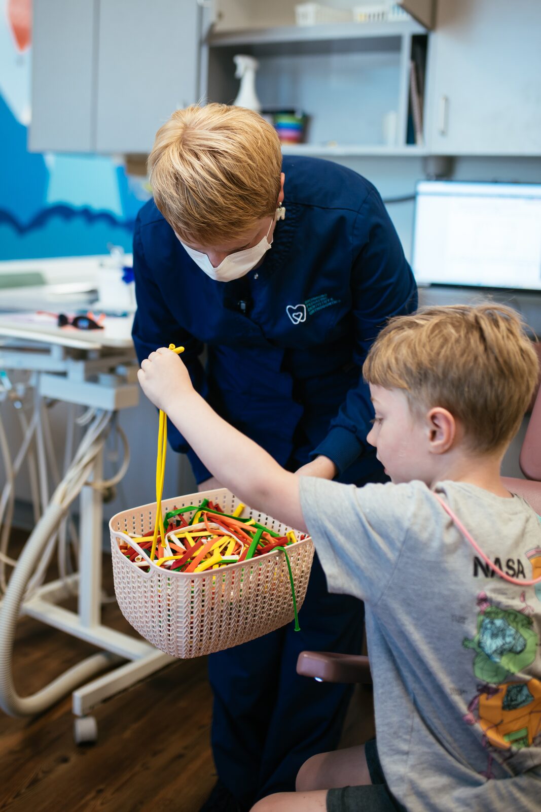 Your Child’s First Visit 7 Young boy picking a prize from the basket after his visit at an RPDO pediatric dental office in Richmond, VA
