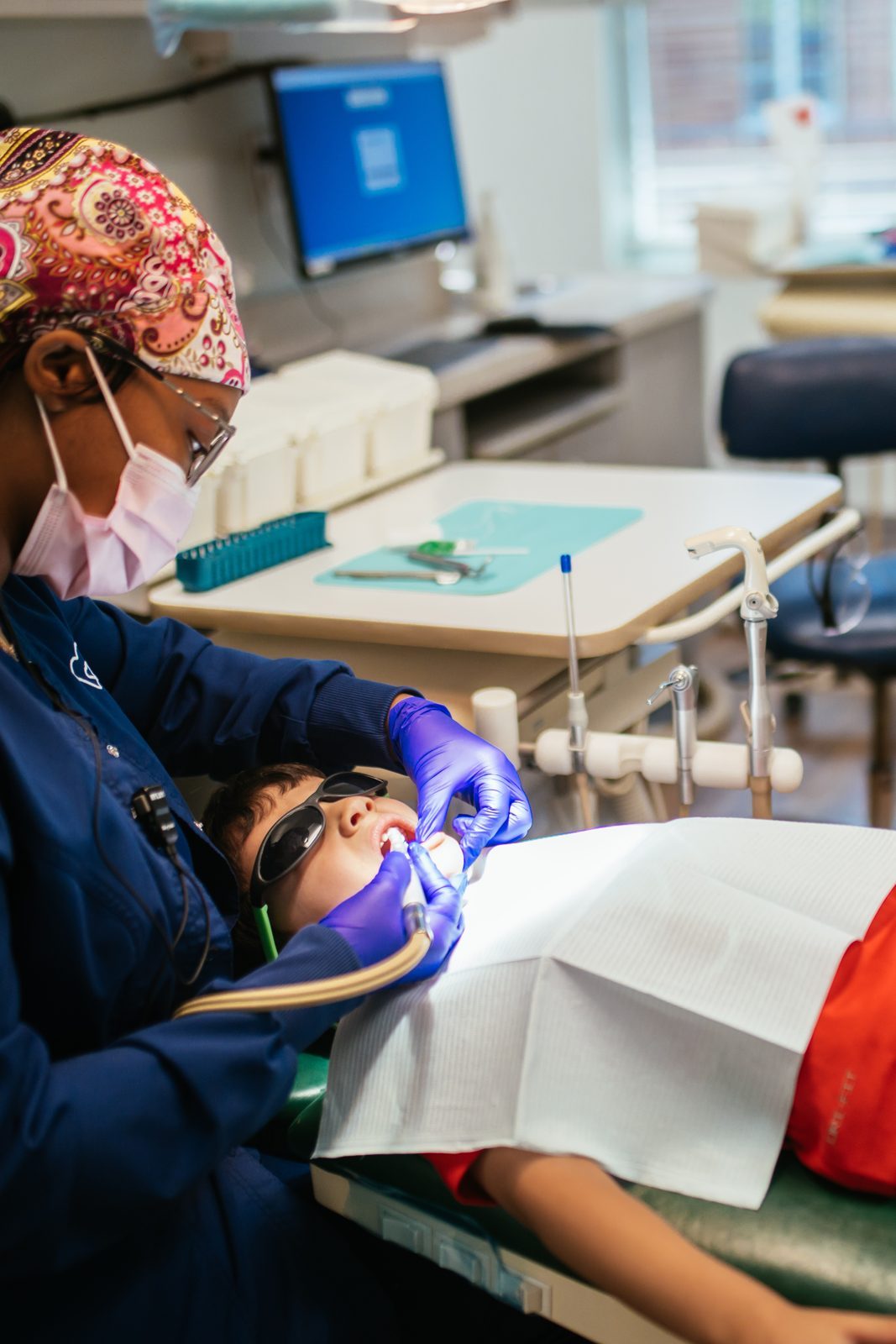 Restorative Dentistry 4 A child wearing kid-sized sunglasses relaxes in the dental chair during a tooth-colored filling appointment at RPDO in Richmond, VA