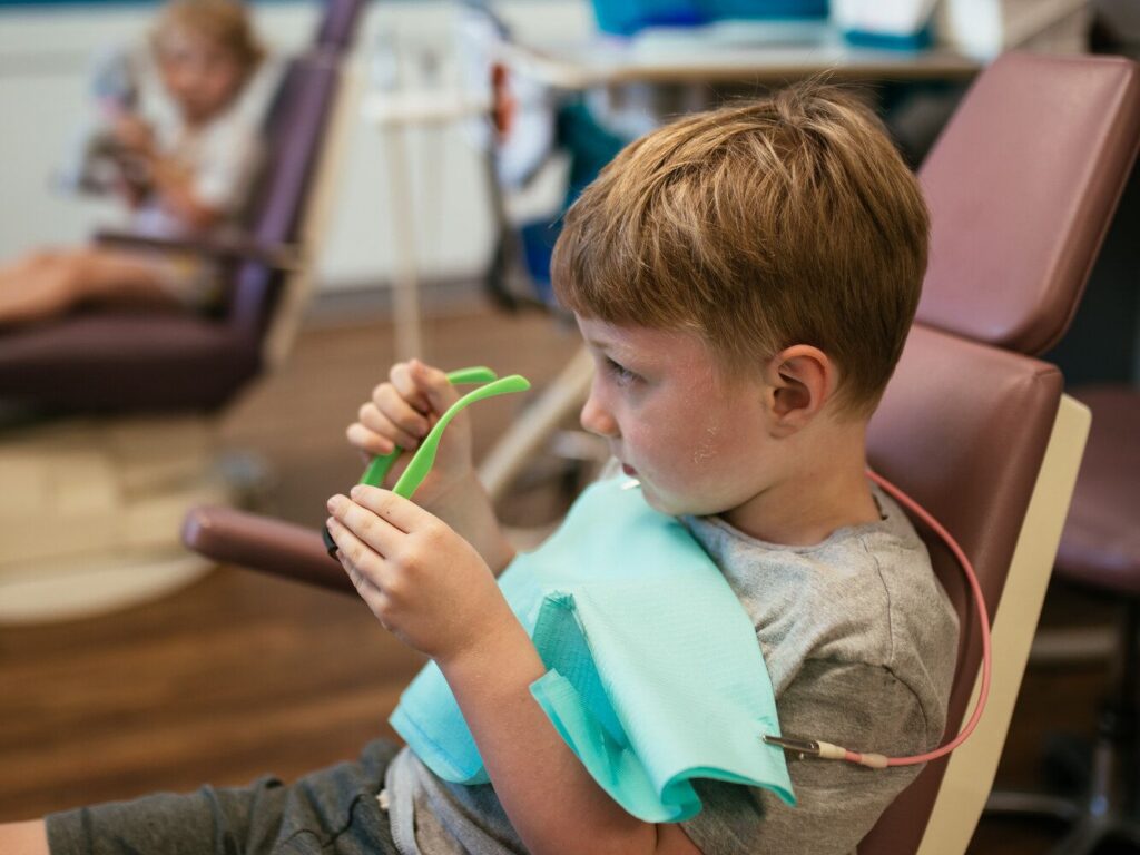 Pediatric Dentist in Chesterfield, VA 3 Pediatric dentist at RPDO checking a young child's teeth, for Chesterfield, VA families