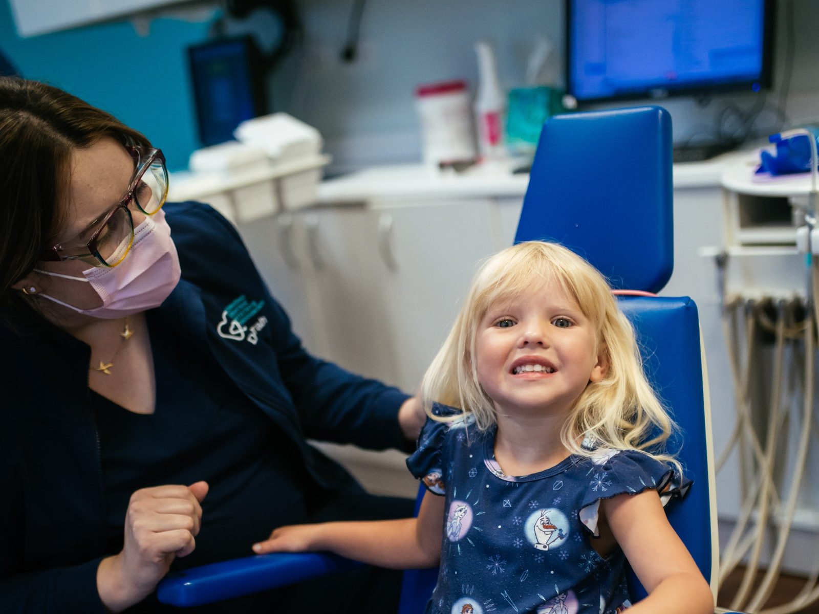 Teeth Cleaning for Kids in Richmond, VA 3 Smiling young patient in the dental chair with an RPDO hygienist before a kids teeth cleaning in Richmond, VA